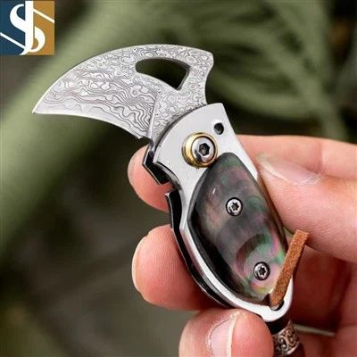 ダマスカスのシェルは、小さな折りたたみナイフを扱います